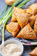 Image showing Homemade samosas sprinkled with sesame seeds.