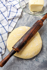 Image showing Dough is rolled out with rolling pin for the dough