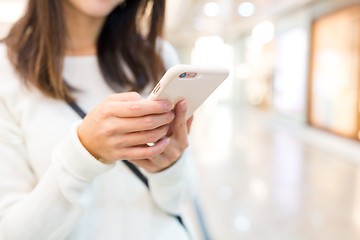 Image showing Woman sending text message on mobile phone