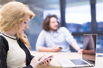 Image showing Elegant Woman Using Mobile Phone in startup office building