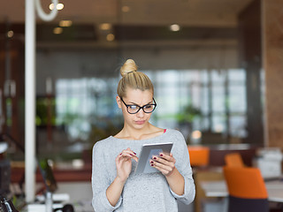 Image showing woman working on digital tablet in night office