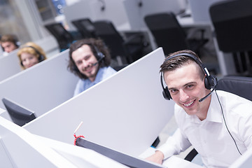 Image showing male call centre operator doing his job