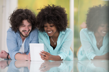 Image showing Couple relaxing together at home with tablet computer