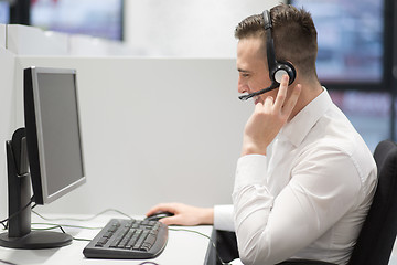 Image showing male call centre operator doing his job