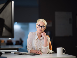 Image showing woman working on computer in dark office