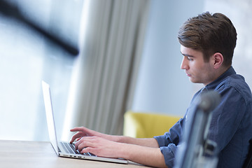 Image showing businessman working using a laptop in startup office