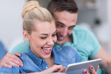 Image showing couple relaxing at  home with tablet computers