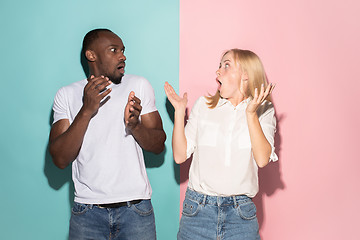 Image showing Beautiful woman and afro woman looking suprised isolated on pink