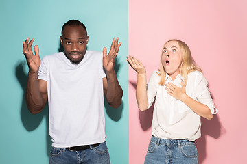 Image showing Beautiful woman and afro woman looking suprised isolated on pink