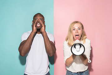 Image showing The young emotional angry woman screaming on pink studio background