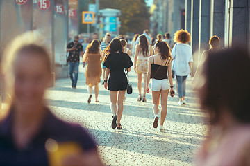 Image showing Beautiful woman holding paper coffee cup and enjoying the walk in the city