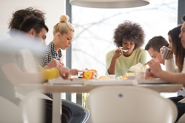 Image showing multiethnic group of happy friends lunch time