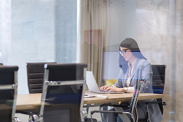 Image showing businesswoman using a laptop in startup office