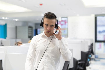 Image showing male call centre operator doing his job