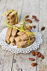 Image showing Fresh Italian cookies cantuccini stacked on white plate and almo