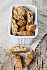 Image showing Italian cookies cantuccini in white ceramic bowl on linen napkin