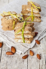 Image showing Fresh Italian cookies cantuccini stacks and almond nuts on linen