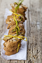 Image showing Fresh Italian cookies cantuccini stackes and white paper on ruct