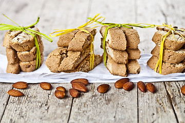 Image showing Fresh Italian cookies cantuccini stackes and almond nuts on ruct