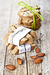 Image showing Fresh Italian cookies cantuccini stackes and almond nuts on ruct