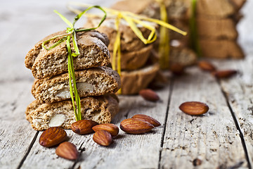 Image showing Fresh Italian cookies cantuccini stackes and almond seeds on ruc