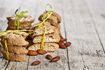 Image showing Fresh Italian cookies cantuccini stackes and almond seeds on ruc