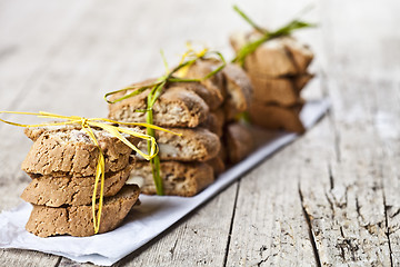 Image showing Fresh Italian cookies cantuccini with almond seeds stacks on whi