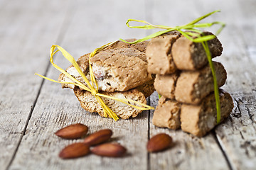 Image showing Fresh Italian cookies cantuccini stacks and almond seeds on ruct