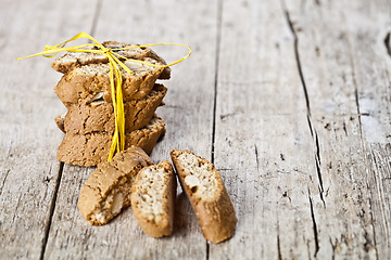 Image showing Fresh Italian cookies cantuccini stack and almond seeds on ructi