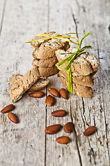 Image showing Fresh Italian cookies cantuccini stackes and almond seeds on ruc