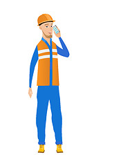 Image showing Young caucasian builder talking on a mobile phone.