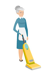 Image showing Chambermaid cleaning floor with a vacuum cleaner.