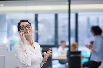 Image showing Elegant Woman Using Mobile Phone in startup office building