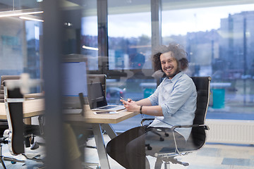 Image showing Young casual businessman using smartphone