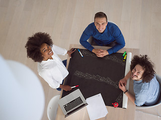 Image showing top view of Multiethnic startup business team on meeting