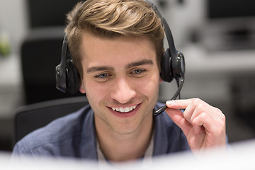 Image showing male call centre operator doing his job