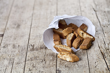 Image showing Traditional Italian cookies cantuccini on white paper bag on ruc