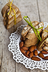 Image showing Fresh Italian cookies cantuccini stacked and almond seeds  on wh