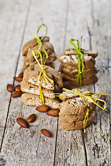 Image showing Fresh Italian cookies cantuccini stackes and almond seeds on ruc