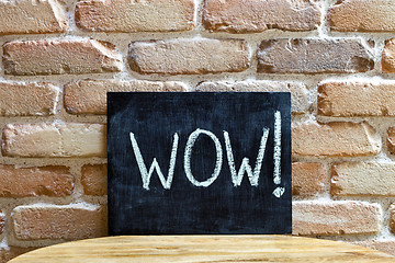 Image showing Chalk board with the word WOW! drown by hand and chalks on woode