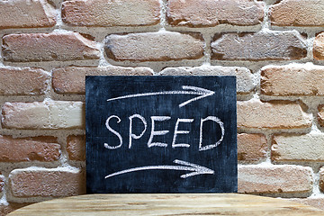 Image showing Chalk board with the word SPEED drown by hand and chalks on wood