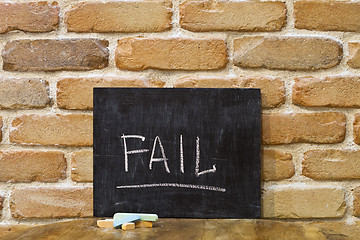 Image showing Chalk board with the word FAIL drown by hand and chalks on woode