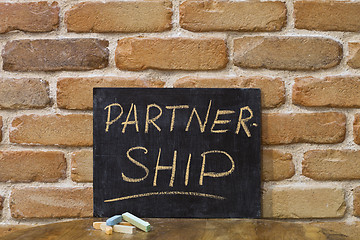 Image showing Chalk board with the word PARTNERSHIP drown by hand and chalks o