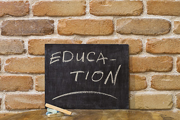 Image showing Chalk board with the word EDUCATION drown by hand and chalks on 