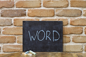 Image showing Chalk board with the word WORD drown by hand and chalks on woode