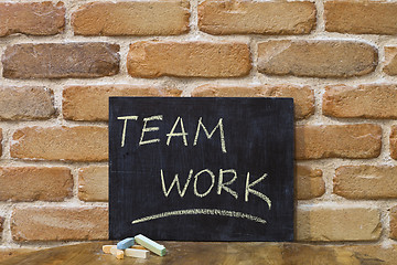 Image showing Chalk board with the word TEAMWORK drown by hand and chalks on w