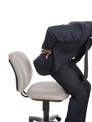 Image showing Man with back pain getting up from chair