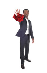 Image showing African man throwing his red tie away