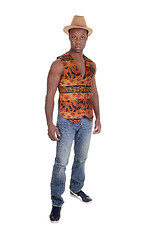 Image showing Tall African man standing in vest and jeans