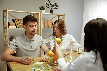 Image showing Smiling nutritionist showing a healthy diet plan to patient